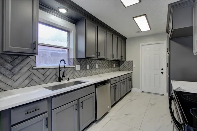 a kitchen with a sink and cabinets