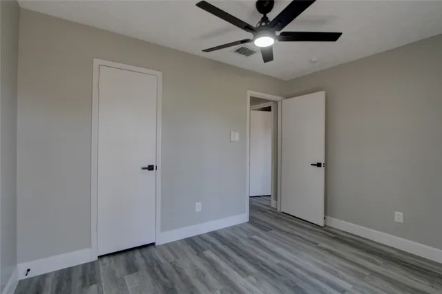 a view of an empty room and wooden floor