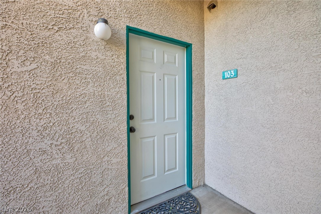 5171 South Lindell Road, Unit 103 Las Vegas, NV 89118 - Photo 4 of 24 A welcoming entry, with a paneled door and vivid trim, invites residents home.