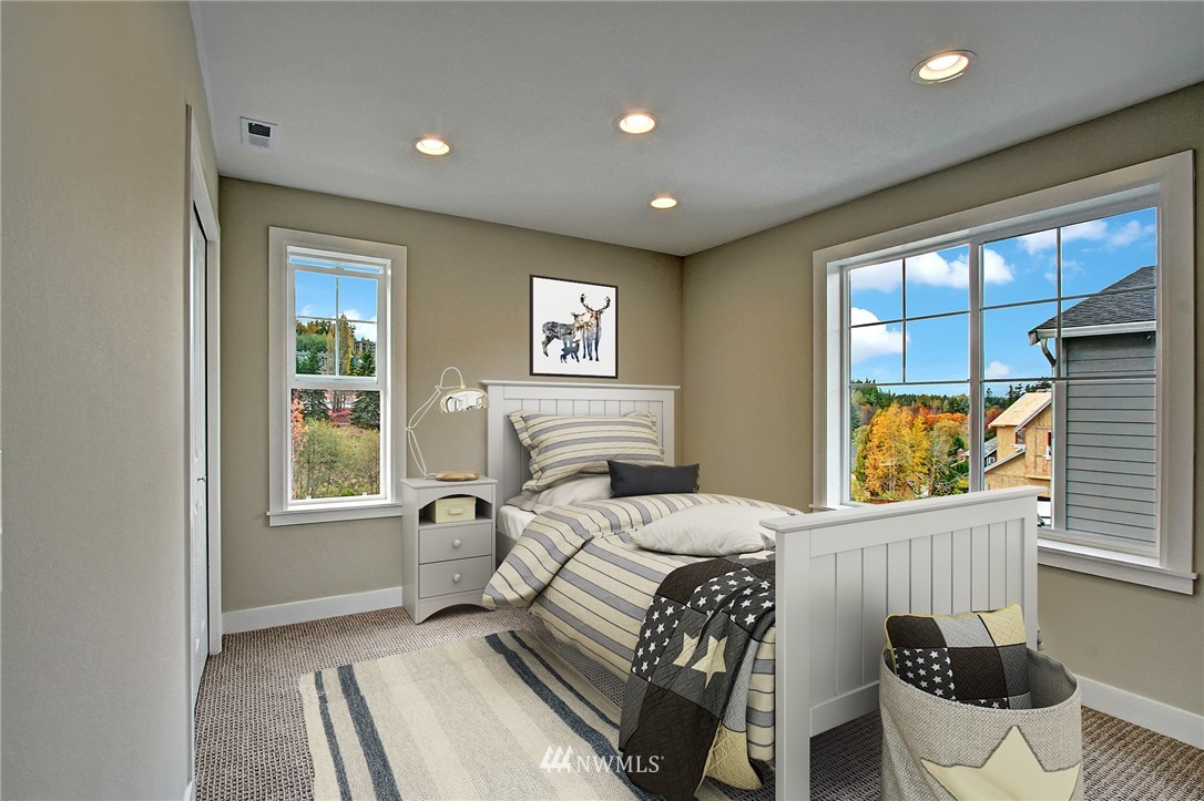 26542 Northeast Big Rock Road, Unit 101 Duvall, WA 98019 - Photo 11 of 19 a bedroom with a bed and a large window