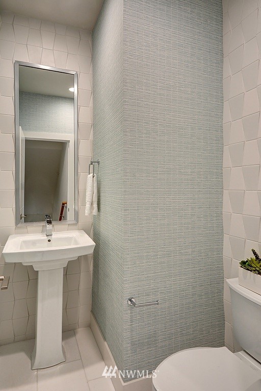 26542 Northeast Big Rock Road, Unit 101 Duvall, WA 98019 - Photo 12 of 19 a bathroom with a toilet sink and mirror