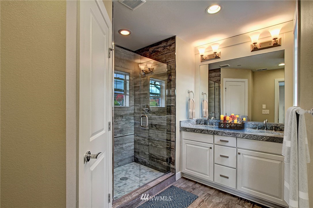 26542 Northeast Big Rock Road, Unit 101 Duvall, WA 98019 - Photo 9 of 19 a bathroom with a double vanity sink and a mirror