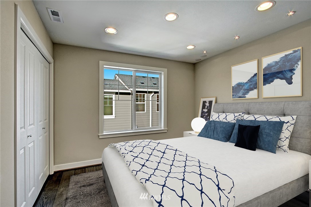 26542 Northeast Big Rock Road, Unit 101 Duvall, WA 98019 - Photo 10 of 19 a bedroom with a large bed and a window