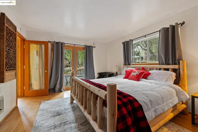 a bedroom with a bed and a large window