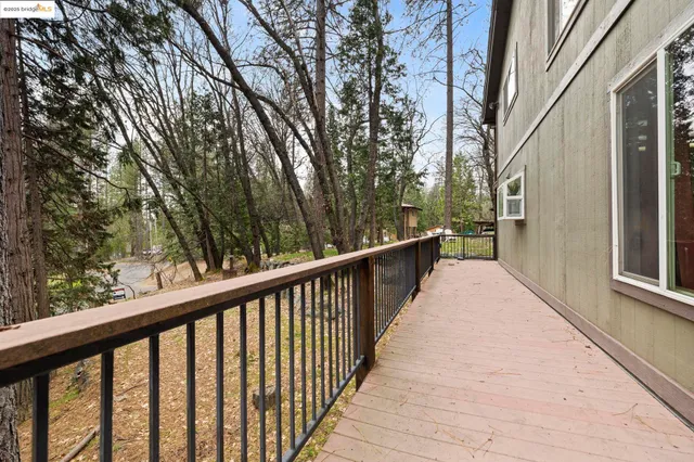 a view of a balcony with wooden floor and fence