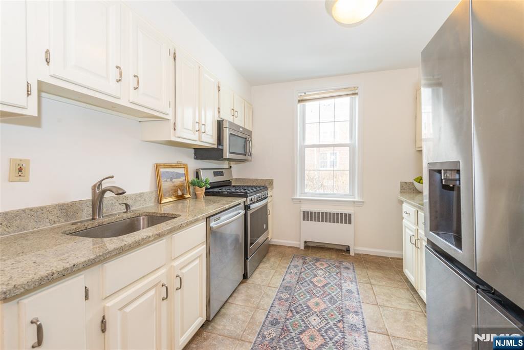 101 Gates Avenue, Unit 2A Montclair, NJ 07042 - Photo 12 of 21 a kitchen with granite countertop a sink stainless steel appliances and cabinets