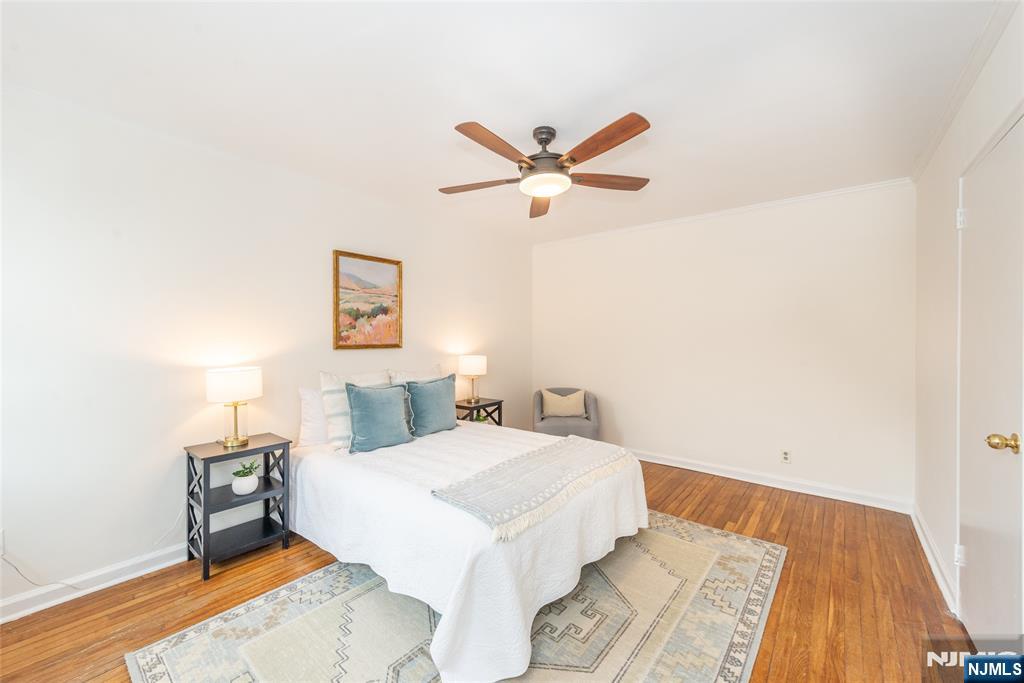 101 Gates Avenue, Unit 2A Montclair, NJ 07042 - Photo 17 of 21 a bedroom with a bed and a chandelier