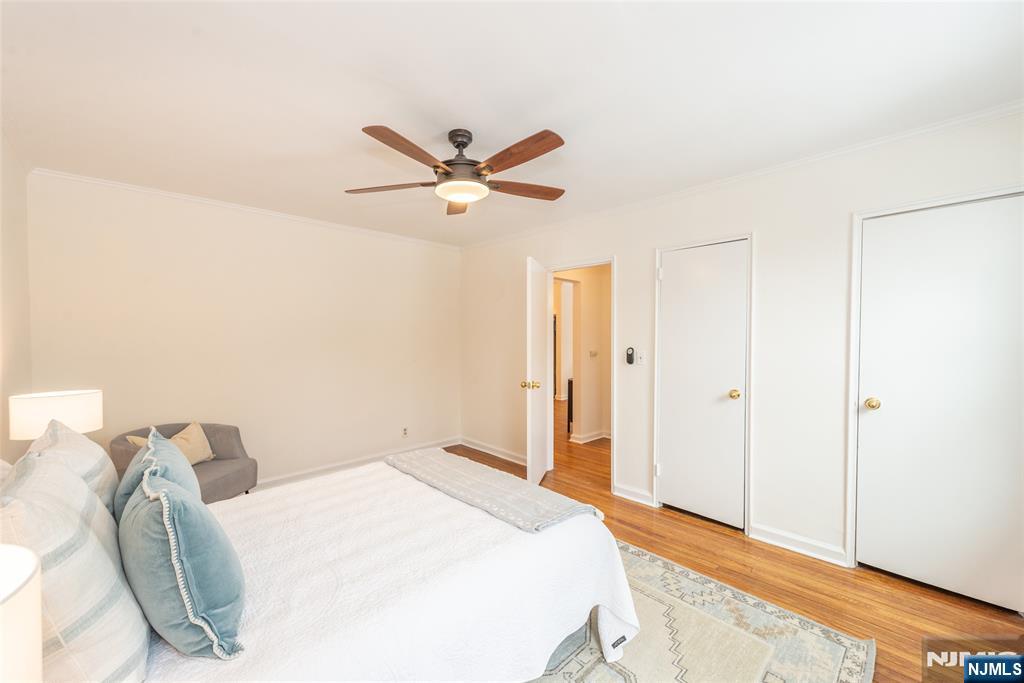 101 Gates Avenue, Unit 2A Montclair, NJ 07042 - Photo 19 of 21 a bedroom with a bed and a chandelier