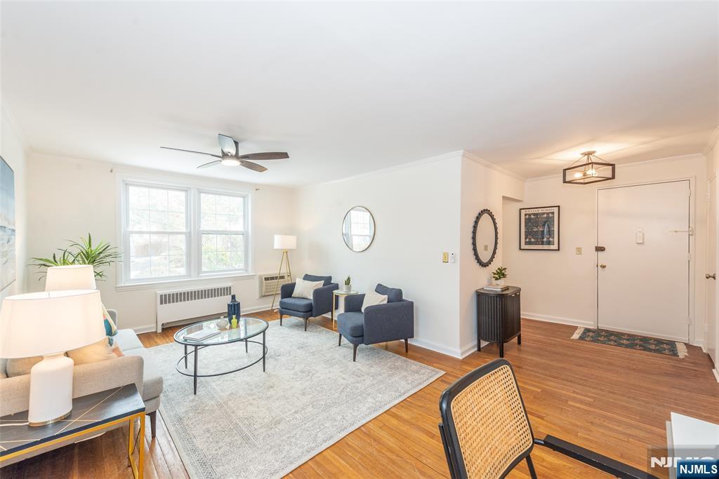 101 Gates Avenue, Unit 2A Montclair, NJ 07042 - Photo 2 of 21 a living room with furniture a table and wooden floor