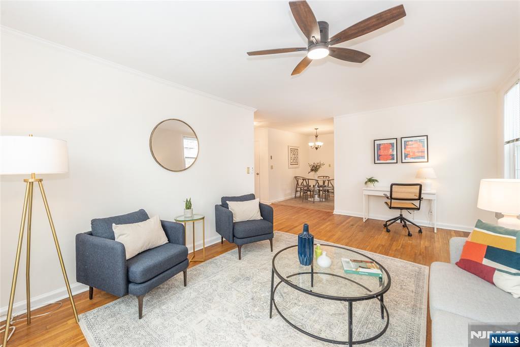 101 Gates Avenue, Unit 2A Montclair, NJ 07042 - Photo 8 of 21 a living room with furniture a rug and a chandelier