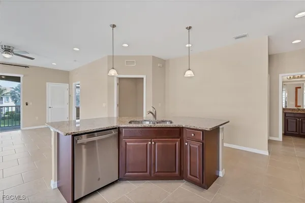 a kitchen with granite countertop a sink and cabinets