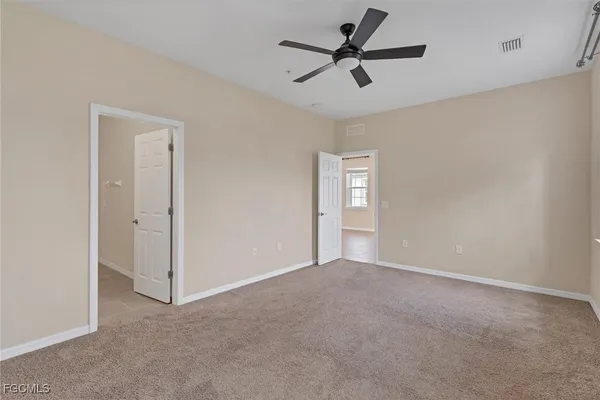 a view of a livingroom with a ceiling fan and window