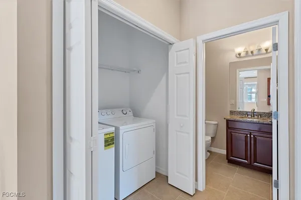 a view of walk in closet with wooden floor