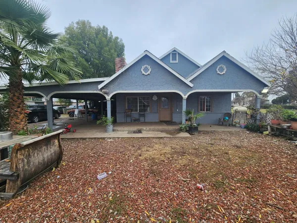 a front view of a house with yard and garage