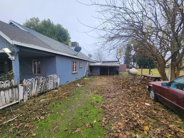 a front view of house with yard and trees