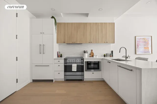 a kitchen with white cabinets and white appliances