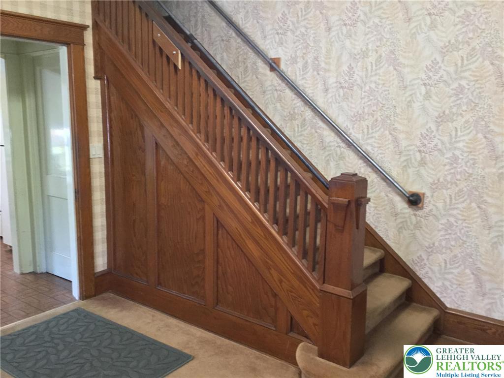 1105 Main Street Slatington, PA 18080 - Photo 5 of 31 Rich wood paneling graces the stairway, leading to the upper level.
