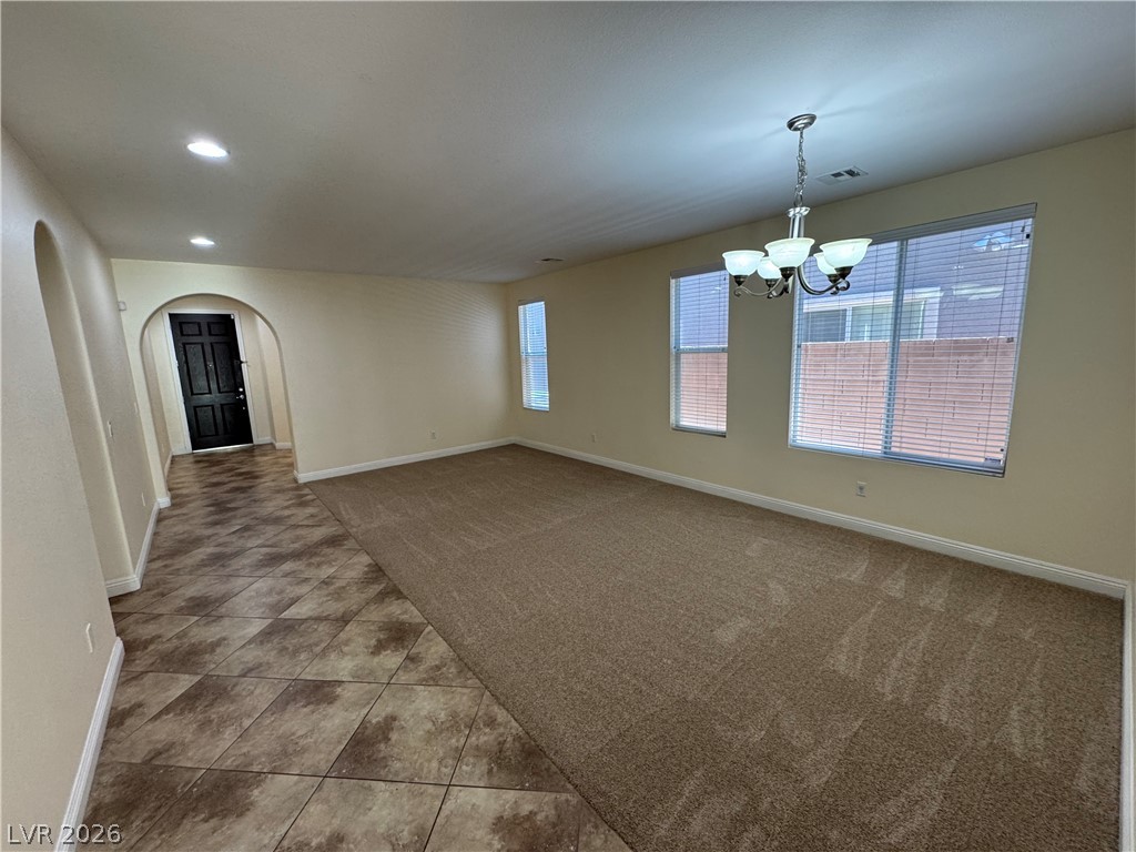 1333 Jamesbury Road Las Vegas, NV 89135 - Photo 8 of 43 A spacious living area combines carpeted comfort with a tiled entryway leading to a grand front door.