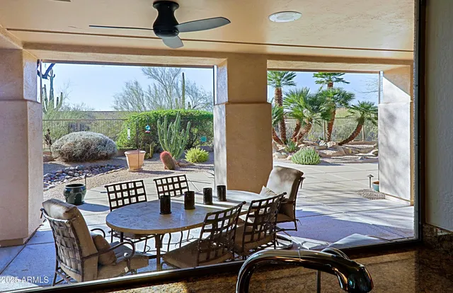 a living room with furniture a chandelier and a window
