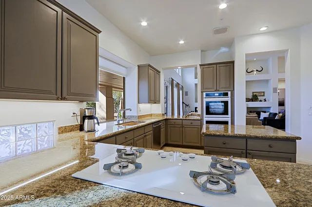a bedroom with a bed potted plant on the dresser and a flat screen tv