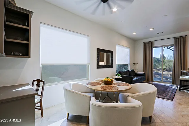 a living room with furniture a flat screen tv and floor to ceiling window