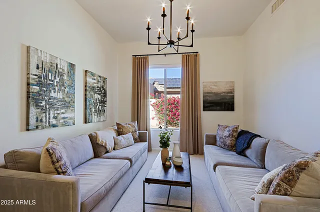 a green field with flowers in front of it