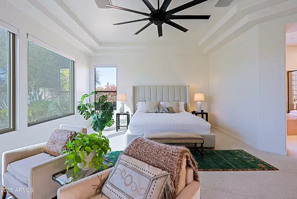 a living room with furniture a rug and a chandelier