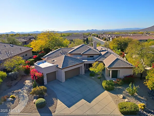 a living room with furniture kitchen view and a chandelier
