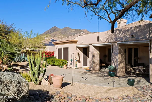 a front view of a house with plants