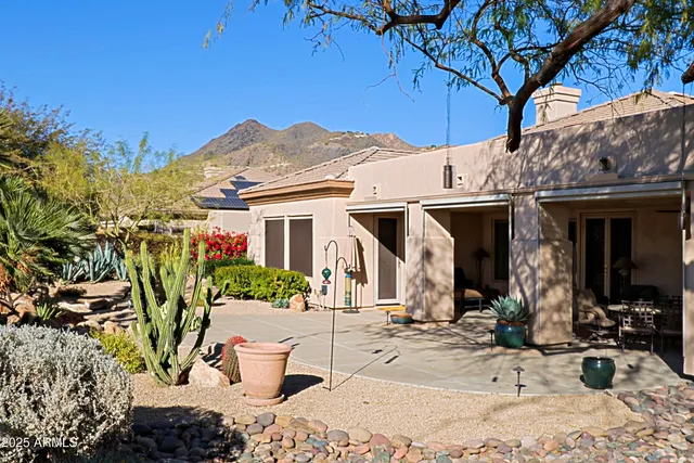 a front view of a house with plants