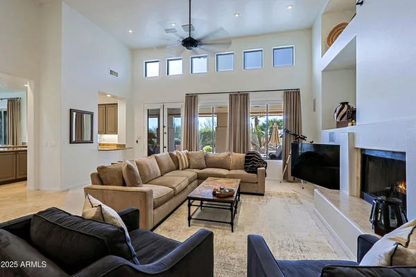 a living room with fireplace furniture and a flat screen tv