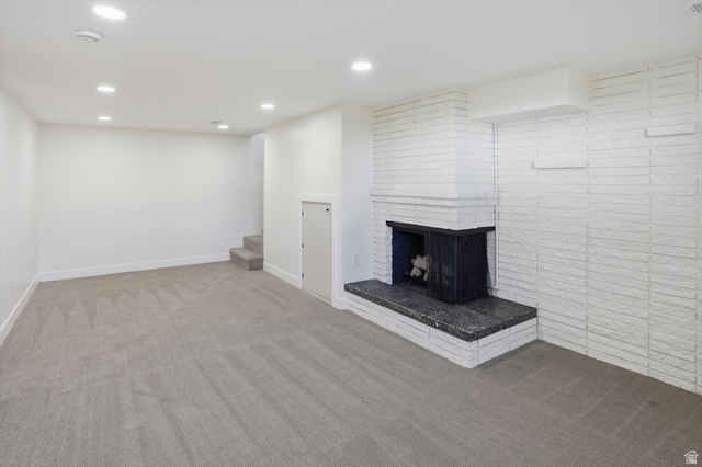 810 East Maple Street Mapleton, UT 84664 - Photo 23 of 49 Spacious room featuring a white painted brick fireplace with a dark stone hearth