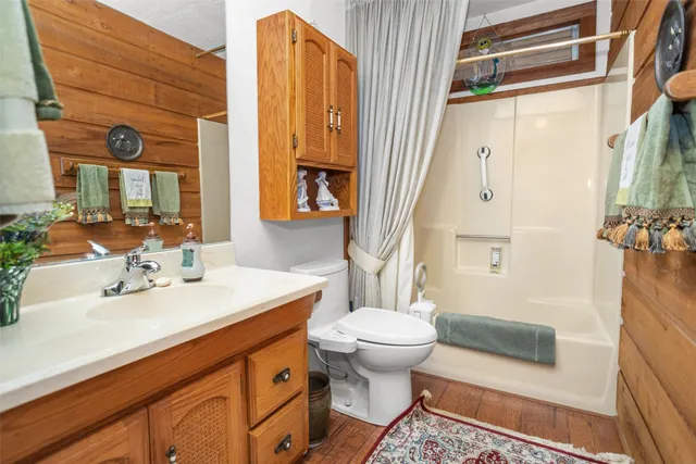 a bathroom with a sink toilet and shower