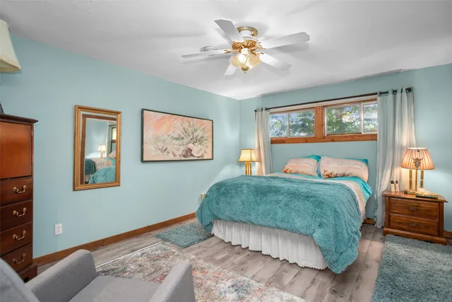 a bedroom with a large bed and a chandelier