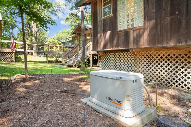 a white house with tree in front of it