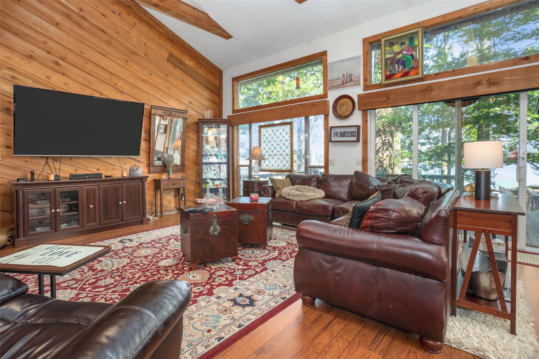 191 Tejas Trail Grapeland, TX 75844 - Photo 7 of 33 a living room with furniture a flat screen tv and a floor to ceiling window