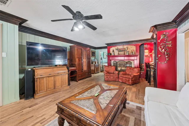 a kitchen with stainless steel appliances granite countertop a stove a refrigerator a dining table and chairs with the view of living room