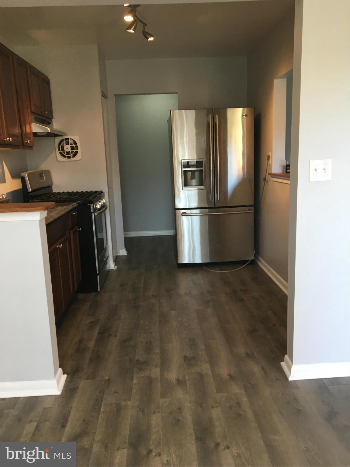 3803 St Barnabas Road, Unit T Suitland, MD 20746 - Photo 2 of 13 a kitchen with granite countertop a refrigerator and a stove