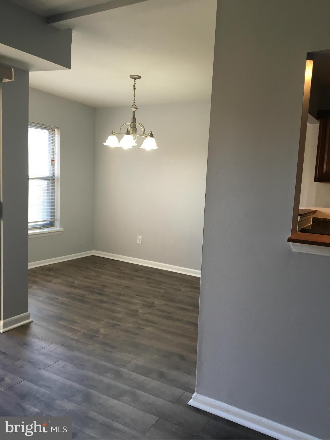 3803 St Barnabas Road, Unit T Suitland, MD 20746 - Photo 6 of 13 an empty room with wooden floor and windows
