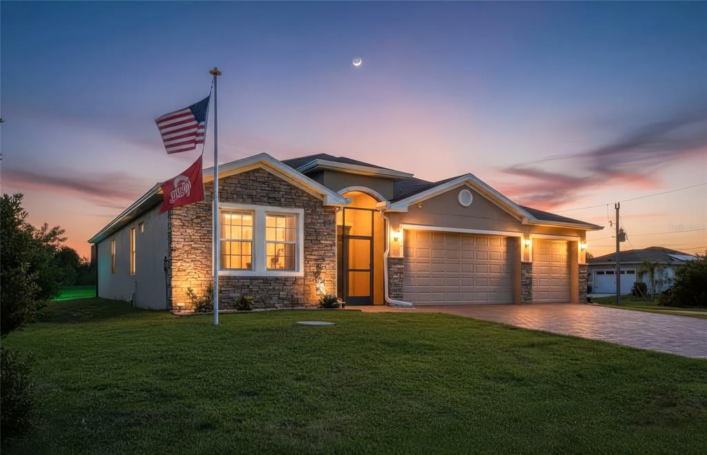 a front view of a house with a yard and garage