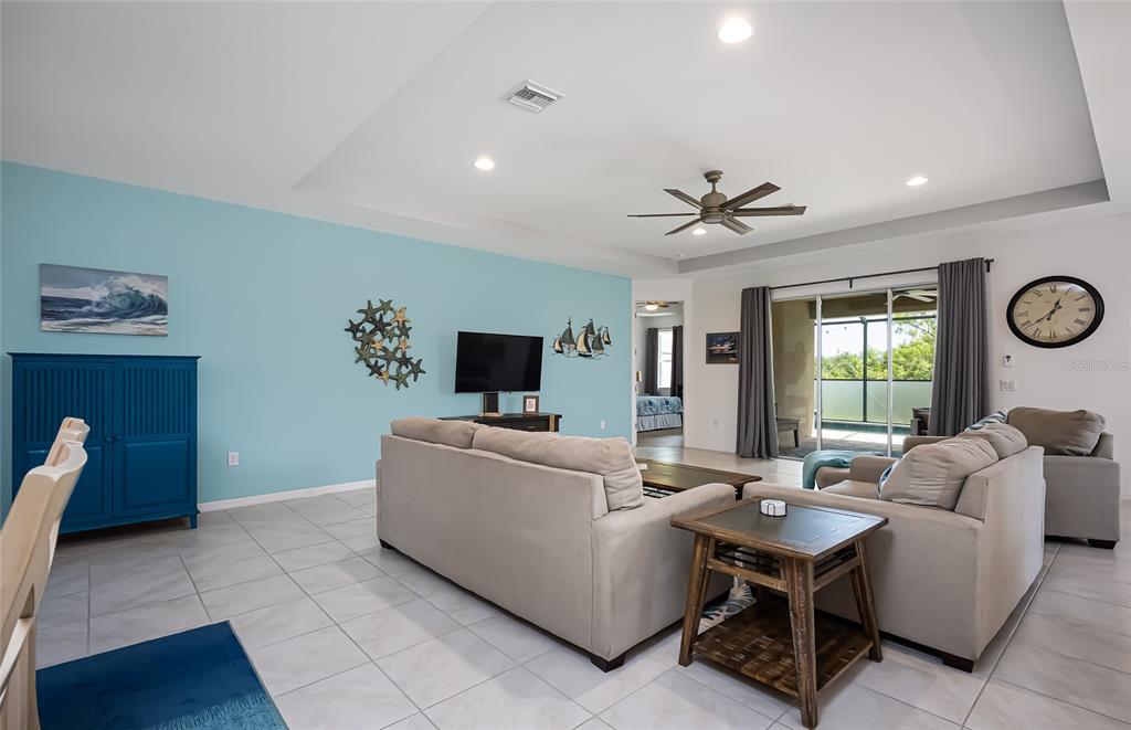 14879 Wichita Road Port Charlotte, FL 33981 - Photo 17 of 74 a living room with furniture a clock and a window