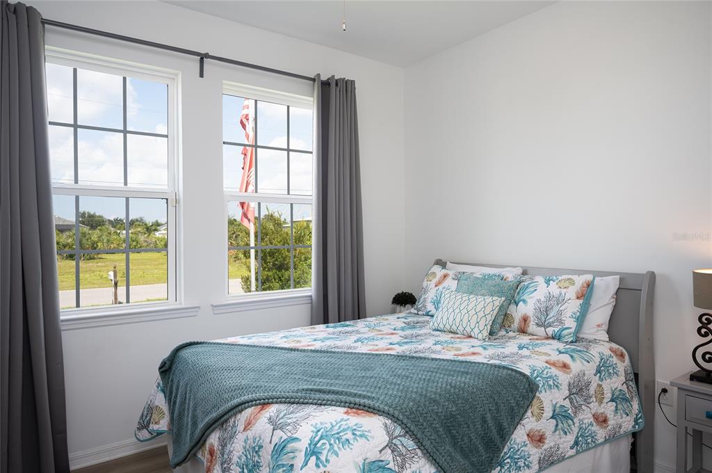 14879 Wichita Road Port Charlotte, FL 33981 - Photo 36 of 74 a bedroom with a bed and a window