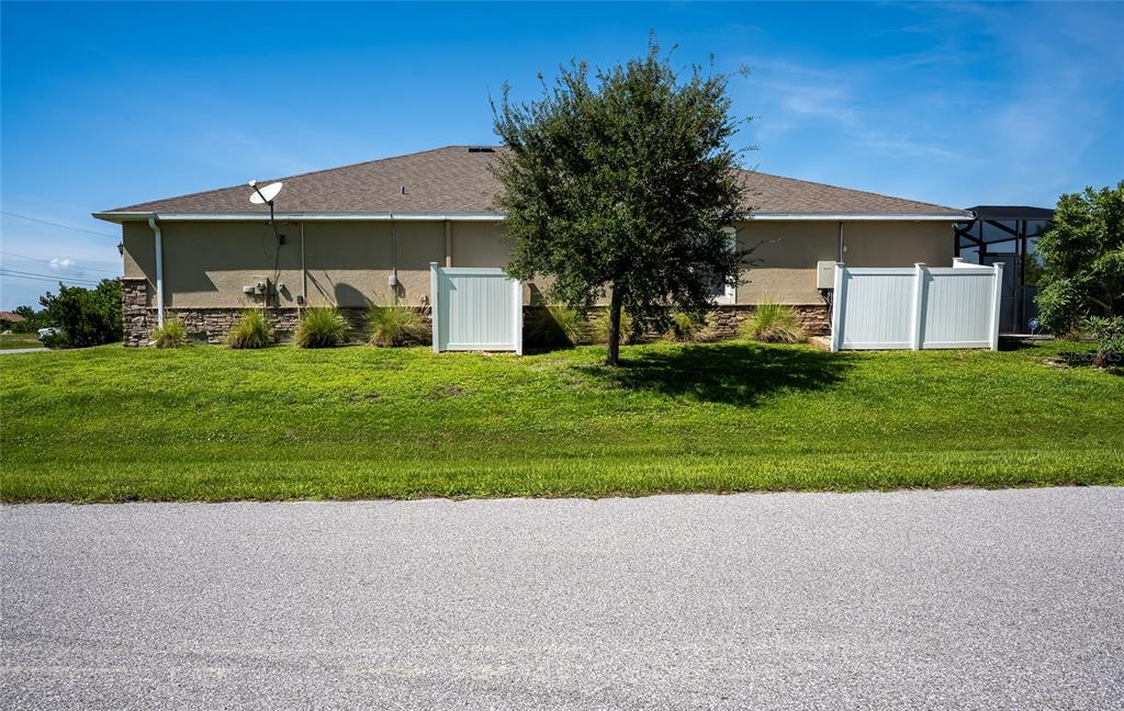 14879 Wichita Road Port Charlotte, FL 33981 - Photo 4 of 74 a front view of a house with a yard and garage