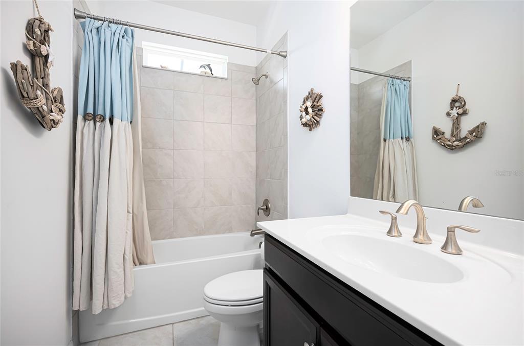 14879 Wichita Road Port Charlotte, FL 33981 - Photo 45 of 74 a bathroom with a sink toilet and shower