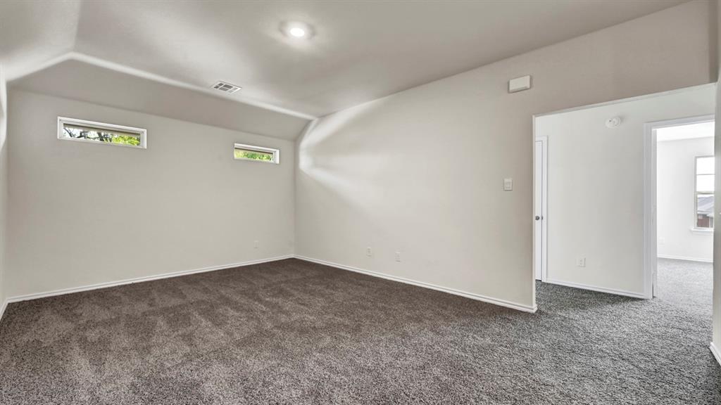 4012 Ripplewood Drive Lindale, TX 75771 - Photo 16 of 37 Carpeted room with recessed lighting, two horizontal transom windows, light gray walls, and white baseboards
