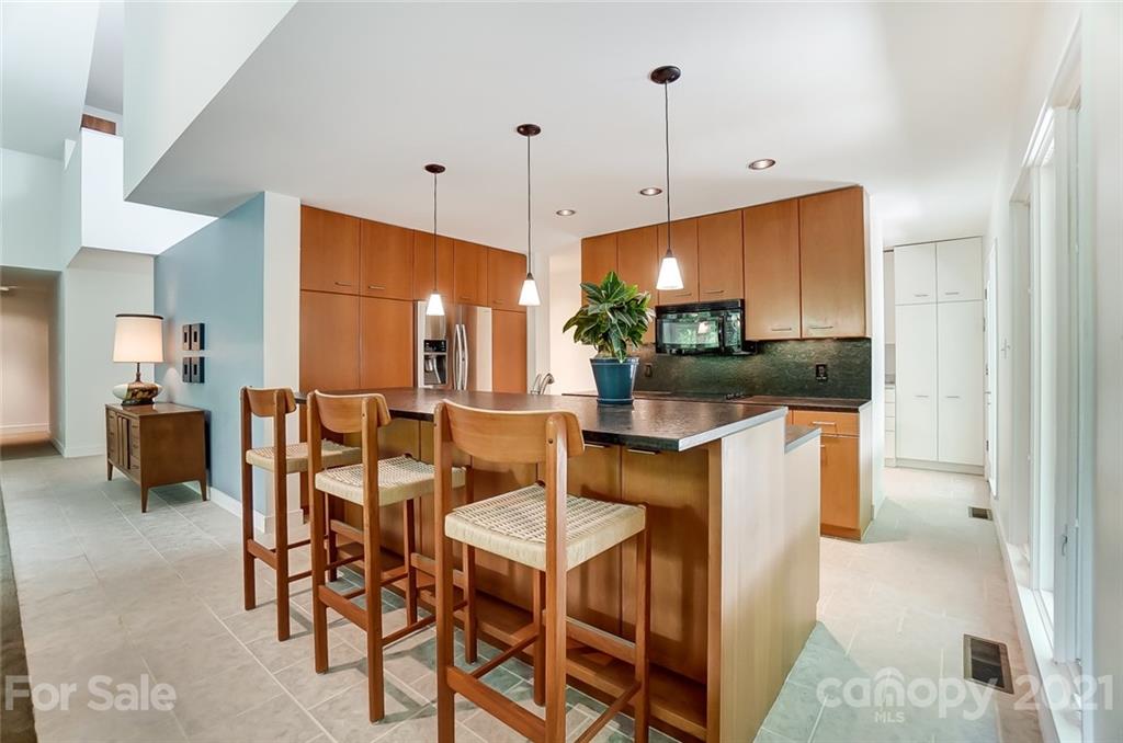 1860 Montague Road Clover, SC 29710 - Photo 14 of 48 a kitchen with stainless steel appliances kitchen island granite countertop a table chairs and a refrigerator