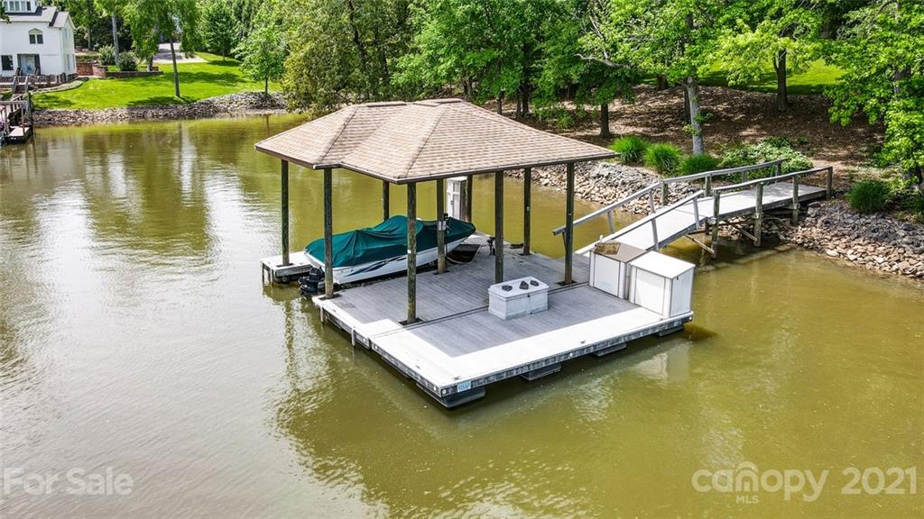 1860 Montague Road Clover, SC 29710 - Photo 47 of 48 a view of a lake with a table and chairs under an umbrella