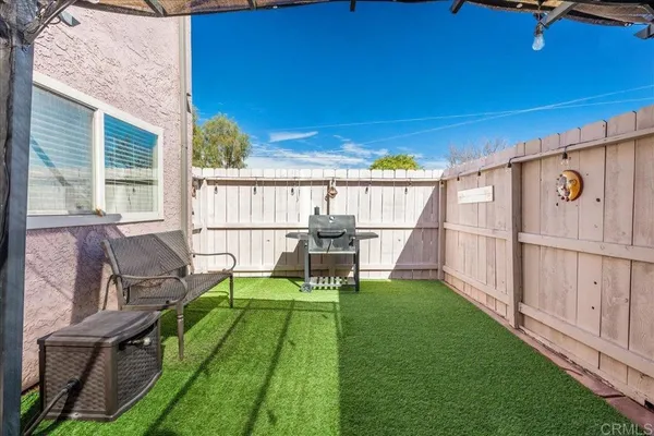 a view of backyard with seating area and furniture