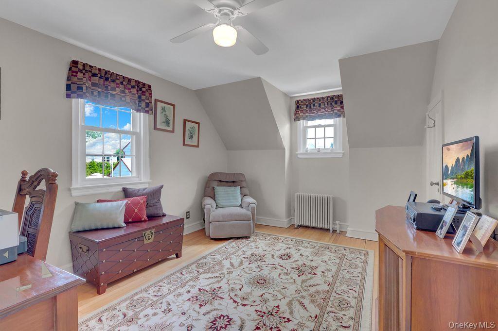 5 Newell Road Merrick, NY 11566 - Photo 13 of 19 a living room with furniture and a flat screen tv