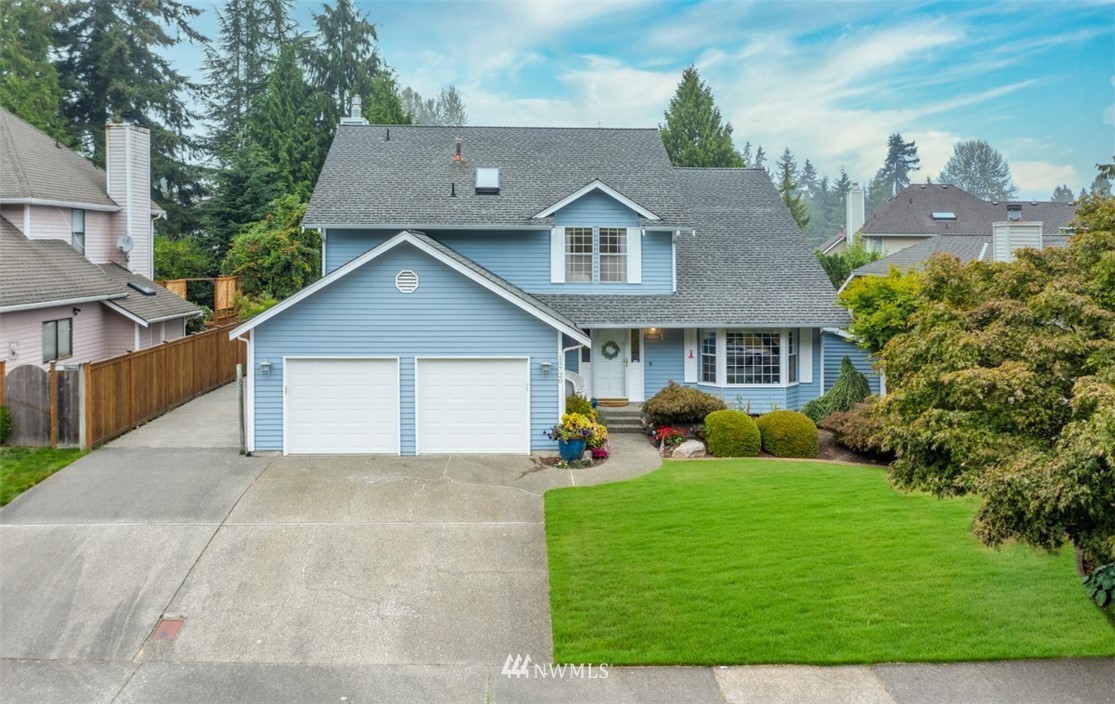 15720 Southeast 184th Street Renton, WA 98058 - Photo 1 of 30 a front view of a house with garden